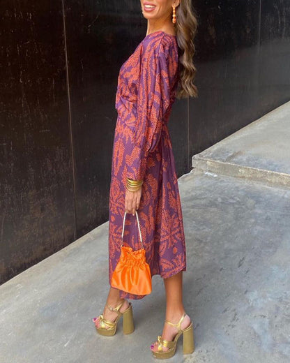 Luxe maxi jurk met diepe V-hals, gouden print en lange mouwen – stijlvolle feestjurk voor dames